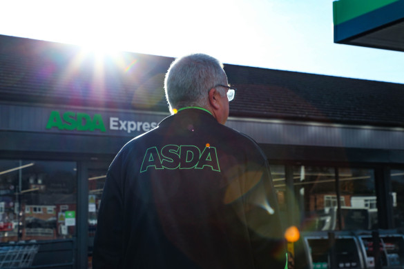 Colleague walking towards Asda Express with sun setting behind