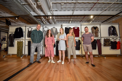 Casually dressed George colleagues in front of clothing rails